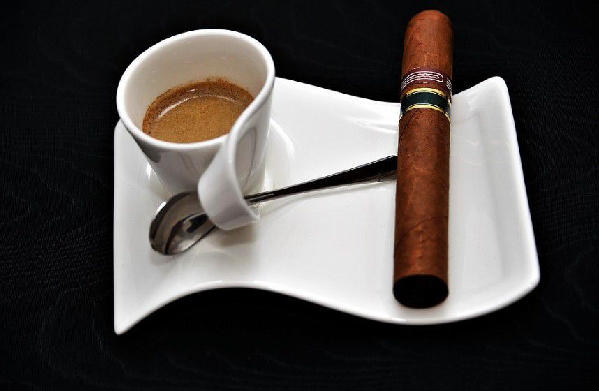 A cigar with a cup of coffee