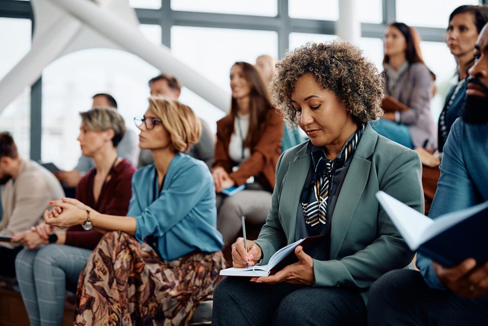 Writers and publishers in a conference hall listening
